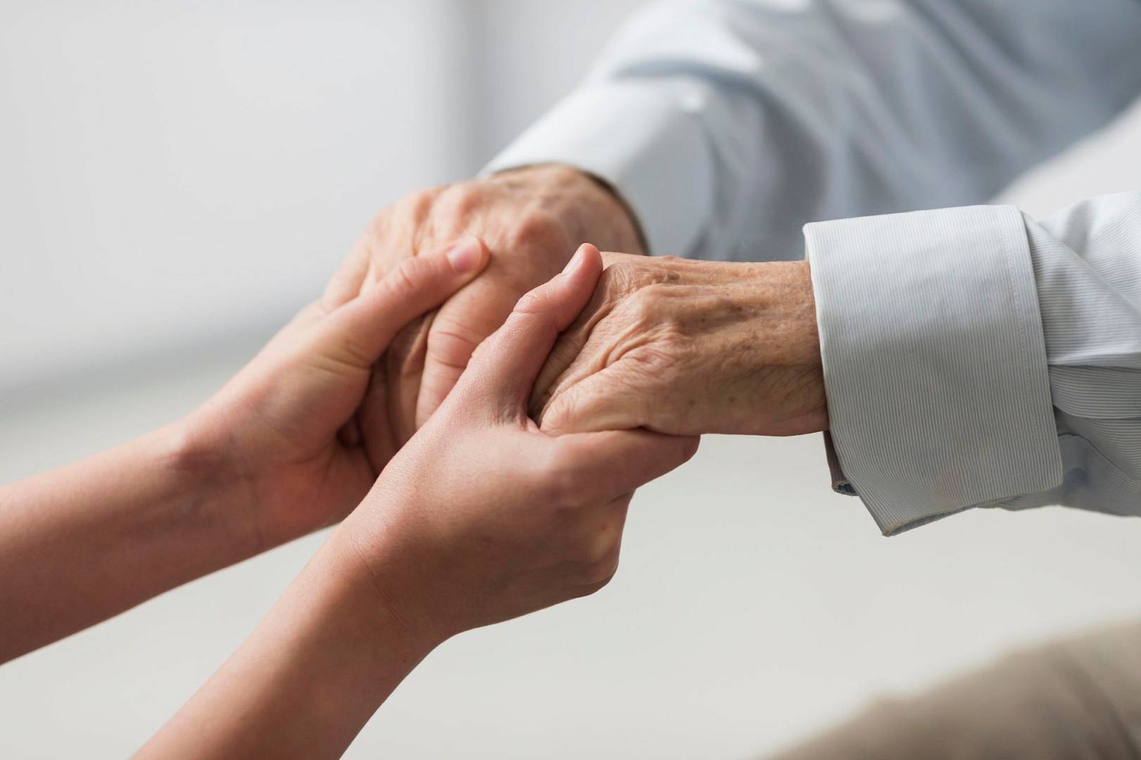 nurse-holding-senior-man-s-hands-sympathy.jpg